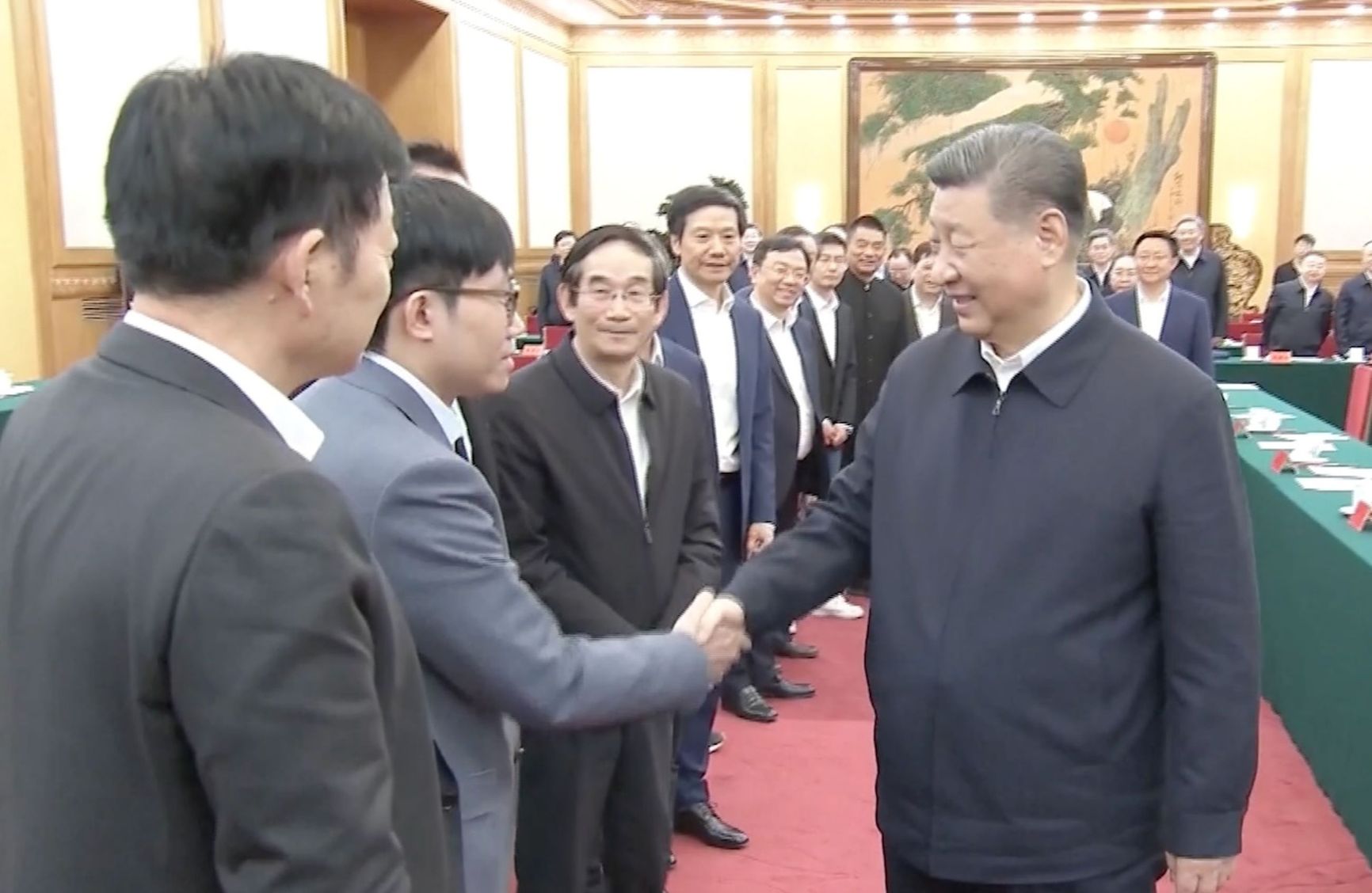 Liang Wenfeng (left) meeting with Xi Jinping